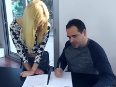 Cute blonde is pressed against the desk where she receives love