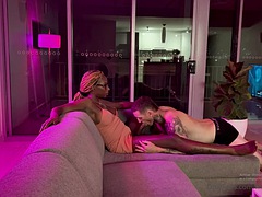 Black Shemale gets a blowjob while watching TV