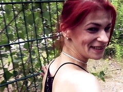 Exhibitionistic redhead girl is sucking a hard cock on the street